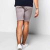 Close-up of athletic shorts. Smooth, flexible fabric, reinforced stitching. Deep black with subtle reflective accents. Workou