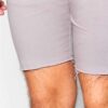 Close-up of athletic shorts. Smooth, flexible fabric, reinforced stitching. Deep black with subtle reflective accents. Workou