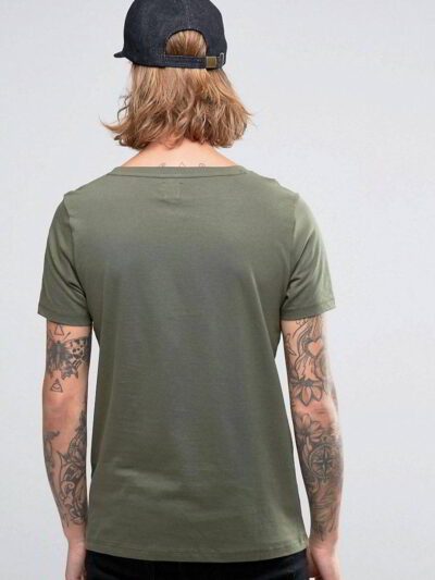Close-up: Printed cotton t-shirt, breathable knit. Detailed stitching, vibrant design. Soft, comfortable wholesale tees in bu