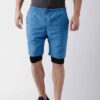 Blue quick-dry swim trunks with white drawstring. Fine stitching details visible. Lightweight, textured fabric. Beachwear. -