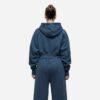 Women's running tracksuit set. Peach-toned heathered fabric, flatlock seams, fitted silhouette. Activewear for gym or outdoor