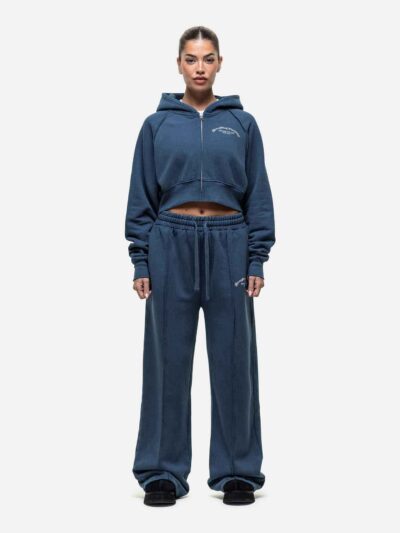 Women's running tracksuit set. Peach-toned heathered fabric, flatlock seams, fitted silhouette. Activewear for gym or outdoor