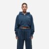 Women's running tracksuit set. Peach-toned heathered fabric, flatlock seams, fitted silhouette. Activewear for gym or outdoor