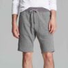Vibrant summer sports shorts with sublimated print. Close-up reveals breathable, lightweight knit. Clean stitching. Perfect f