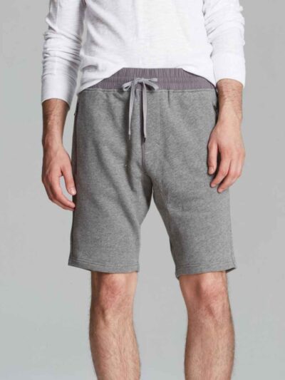 Vibrant summer sports shorts with sublimated print. Close-up reveals breathable, lightweight knit. Clean stitching. Perfect f