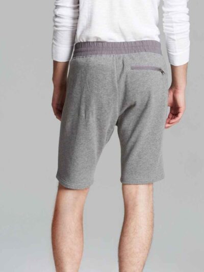 Vibrant summer sports shorts with sublimated print. Close-up reveals breathable, lightweight knit. Clean stitching. Perfect f