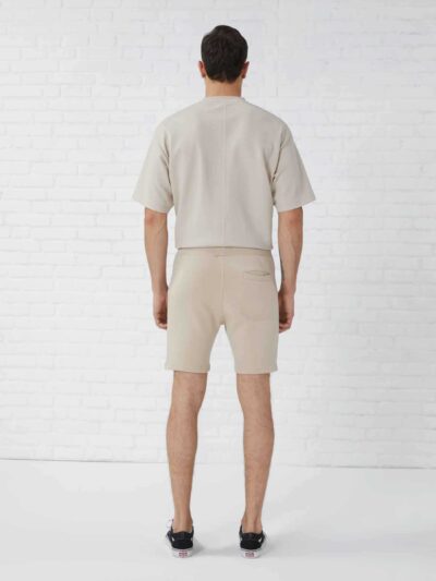Vintage washed men's oversized t-shirt and shorts set. Textured fabric, relaxed fit, subtle seam detailing. Perfect casual st