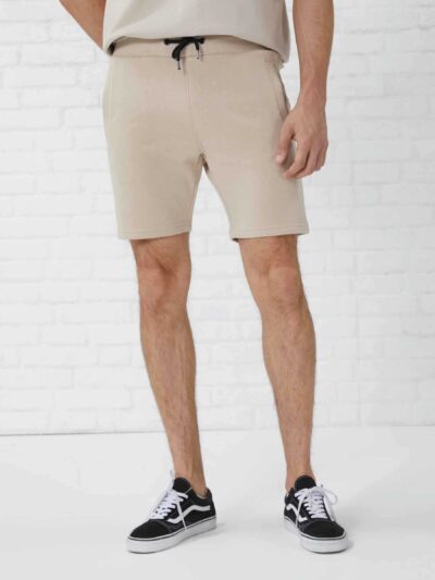 Vintage washed men's oversized t-shirt and shorts set. Textured fabric, relaxed fit, subtle seam detailing. Perfect casual st