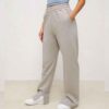 Women's active wear tracksuit. Close-up on textured fabric, vibrant stitching, multiple logo placements. Sporty chic design,