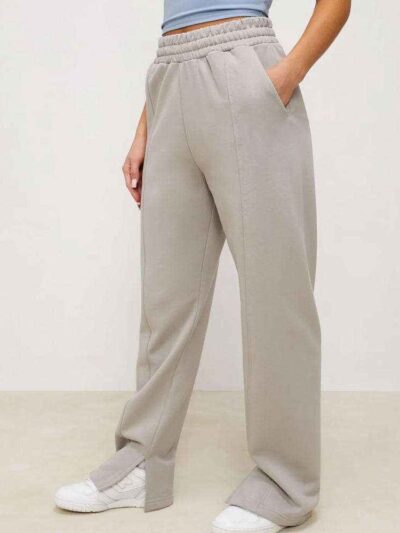 Women's active wear tracksuit. Close-up on textured fabric, vibrant stitching, multiple logo placements. Sporty chic design,