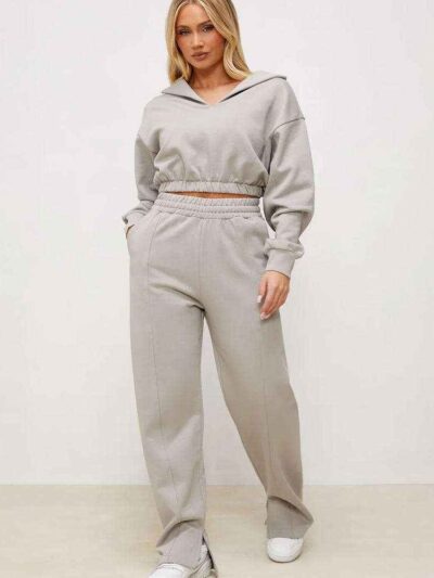 Women's active wear tracksuit. Close-up on textured fabric, vibrant stitching, multiple logo placements. Sporty chic design,