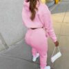Women's tracksuit. Soft, brushed fleece. Screen printed logo detail. Custom color option. Ribbed cuffs & hem. Sporty, comfort