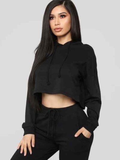 Women's black cropped tracksuit. Sleek, form-fitting design. Ribbed texture on the crop top and high-waisted bottoms. Visible