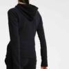 Black tracksuit featuring a hooded jacket with a visible zipper and matching pants. Fine stitching and soft-looking fabric te