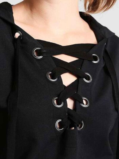 Women's lace-up tracksuit. Close-up shows soft, textured fabric. Dark grey with subtle stitch detailing. Sporty two-piece set