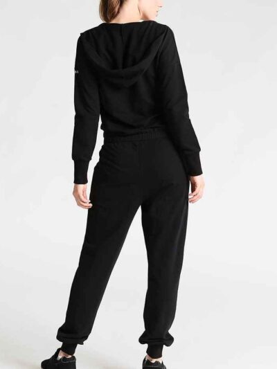 Women's lace-up tracksuit. Close-up shows soft, textured fabric. Dark grey with subtle stitch detailing. Sporty two-piece set