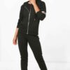 Women's sporty two-piece tracksuit. Stretchy, form-fitting polyester-spandex blend. Visible fine stitching details. Teal and