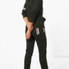Women's sporty two-piece tracksuit. Stretchy, form-fitting polyester-spandex blend. Visible fine stitching details. Teal and