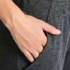 Slim-fit women's tracksuit in soft cotton. Close-up shows fine stitching & comfortable ribbed cuffs. Athletic style, perfect