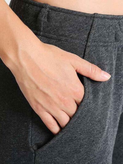Slim-fit women's tracksuit in soft cotton. Close-up shows fine stitching & comfortable ribbed cuffs. Athletic style, perfect