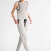 Women's ribbed knit tracksuit set. Close-up shows fine vertical ribbing texture. Soft heathered rose color. Comfortable, styl