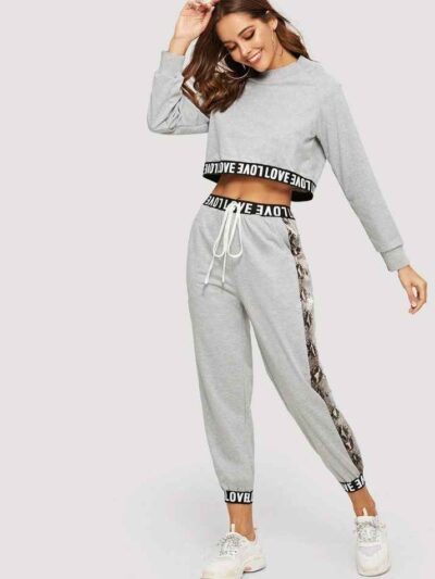 Woman's cropped sweatsuit, light cotton. Short sleeves, high-waisted bottoms. Premium stitching visible. Designed for style a