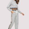 Woman's cropped sweatsuit, light cotton. Short sleeves, high-waisted bottoms. Premium stitching visible. Designed for style a
