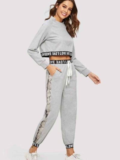 Woman's cropped sweatsuit, light cotton. Short sleeves, high-waisted bottoms. Premium stitching visible. Designed for style a