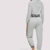 Woman's cropped sweatsuit, light cotton. Short sleeves, high-waisted bottoms. Premium stitching visible. Designed for style a