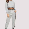 Woman's cropped sweatsuit, light cotton. Short sleeves, high-waisted bottoms. Premium stitching visible. Designed for style a