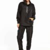 Black woven women's windbreaker tracksuit. Lightweight, subtle sheen, durable stitching. A modern athletic set perfect for la