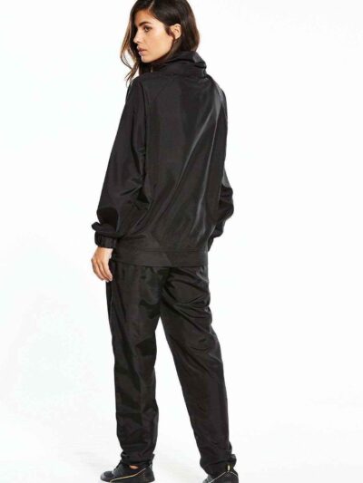 Black woven women's windbreaker tracksuit. Lightweight, subtle sheen, durable stitching. A modern athletic set perfect for la