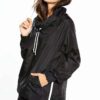 Black woven women's windbreaker tracksuit. Lightweight, subtle sheen, durable stitching. A modern athletic set perfect for la