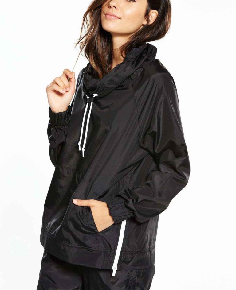 Black woven women's windbreaker tracksuit. Lightweight, subtle sheen, durable stitching. A modern athletic set perfect for la