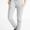 Women's workout set: Sleek jogging suit in heathered grey. Ribbed cuffs, subtle contouring seams. Soft, flexible athletic fab