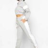 Cropped tracksuit with vibrant color blocking. Notice the textured fabric and neat stitching on this athletic-style top and b
