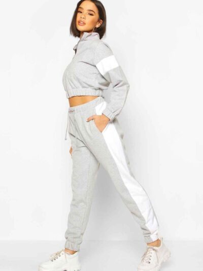 Cropped tracksuit with vibrant color blocking. Notice the textured fabric and neat stitching on this athletic-style top and b