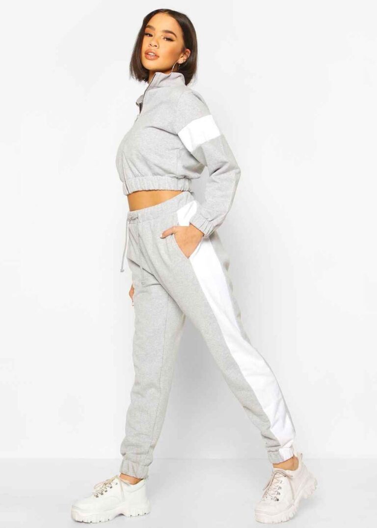 Cropped tracksuit with vibrant color blocking. Notice the textured fabric and neat stitching on this athletic-style top and b