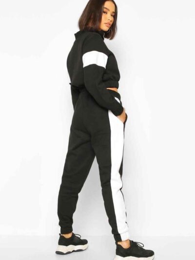 Cropped tracksuit with vibrant color blocking. Notice the textured fabric and neat stitching on this athletic-style top and b