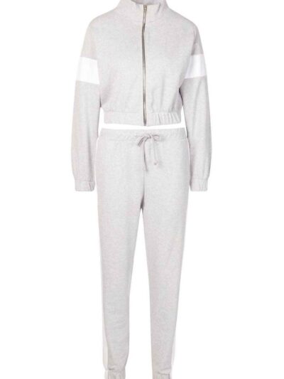 Cropped tracksuit with vibrant color blocking. Notice the textured fabric and neat stitching on this athletic-style top and b