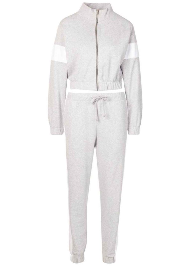 Cropped tracksuit with vibrant color blocking. Notice the textured fabric and neat stitching on this athletic-style top and b