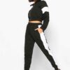 Cropped tracksuit with vibrant color blocking. Notice the textured fabric and neat stitching on this athletic-style top and b