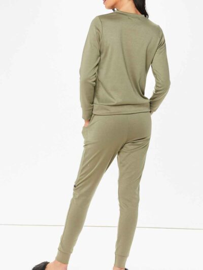Crewneck sweatsuit with bust zipper. Soft, plush fabric, visible stitching. Custom lounge set, likely pastel or neutral tone.