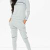 Crewneck sweatsuit with bust zipper. Soft, plush fabric, visible stitching. Custom lounge set, likely pastel or neutral tone.