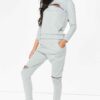 Crewneck sweatsuit with bust zipper. Soft, plush fabric, visible stitching. Custom lounge set, likely pastel or neutral tone.