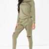 Crewneck sweatsuit with bust zipper. Soft, plush fabric, visible stitching. Custom lounge set, likely pastel or neutral tone.